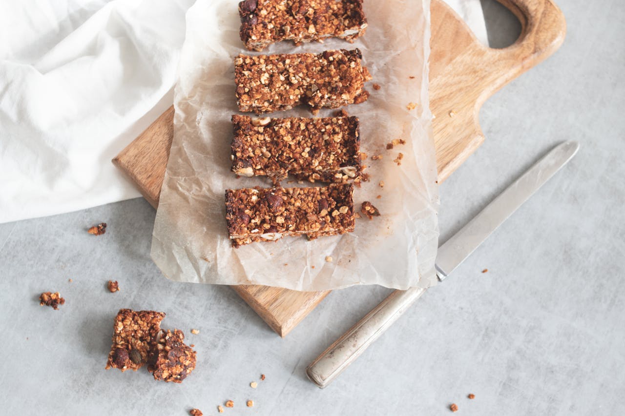 about-07 Delicious homemade granola bars on a wooden board, perfect for healthy snacking and meal preparation.